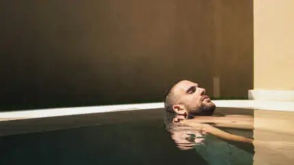 Person taking a cold plunge in a wellness tub
