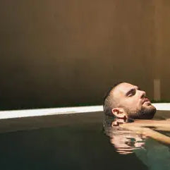 Person taking a cold plunge in a wellness tub